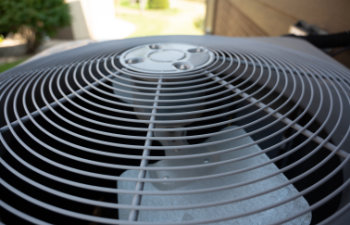 top view of residential air conditioning unit outdoors with fan and coils